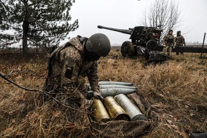 Ukrainian soldier loading shells