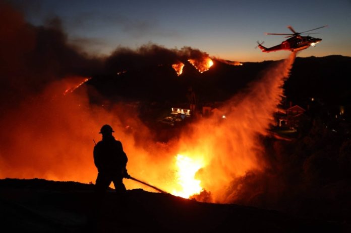 Wildfire rages in Los Angeles, forcing thousands to evacuate